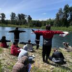 Andrea Watts / The Daily World
Kathy Jacobs walked the students through observations of the river, such as drawing the weather, estimating how far to the opposite side of the bank, noticing the visibility of the water and noting ripples in the water.
