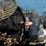Luke Whittaker photos / Chinook Observer
Oystermen Brandon Christman and Otto Kemmer unload oyster tubs on Saturday, May 30, in Willapa Bay. Commercial oyster crews have been busy in recent weeks moving the oysters to new beds ahead of the summer season.