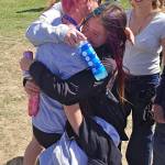 SUBMITTED PHOTO Ocostas Ailyn Haggard (glasses) is hugged by teammates Ella Kachman and Kat Nersten (right) after winning the 1B Girls 800 State Championship on May 30 in Yakima.