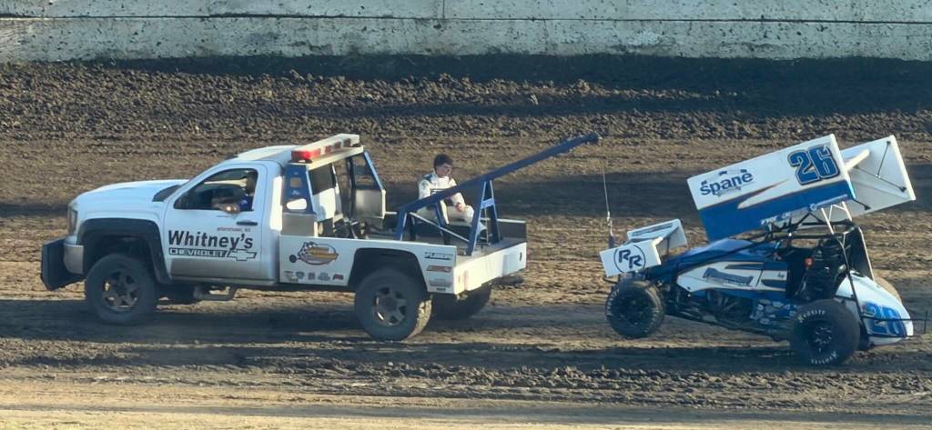 A dejected Levi Hillier from Burlington exits the racetrack from the back of the Whitneys tow truck after his sprint car was disabled. Earlier, the sixteen year old Hillier posted the Quick Time Monday.