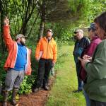 Andrea Watts / The Daily World
Patrick Mahoney, a forest resource management instructor at Grays Harbor College, John Henrikson and students discuss how to identify one of the native tree species that have been planted on the property.