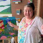 Jerry Knaak / The Daily World
Amber Buck shows off her artwork at Harbor Books in Hoquiam.