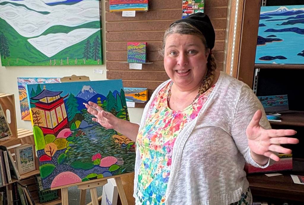Jerry Knaak / The Daily World
Amber Buck shows off her artwork at Harbor Books in Hoquiam.
