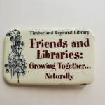 Andrea Watts / The Daily World
This pin that Montesano Friends of the Library member Helen Hepp had obtained sometime ago reflected a partnership between Friends groups and Timberland Regional Library that became strained under the leadership of former Executive Director Cheryl Heywood but is now being rebuilt.