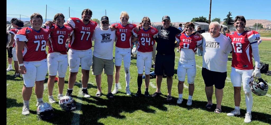T. Michaels / The Daily World
Bulldog Seniors and former Montesano coaches take a final photo together at the East vs. West football game in Yakima.