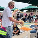 Jerry Knaak / The Daily World
Don The Reptile King Riggs introduces visitors to Reptile Isle to an albino Burmese python.
