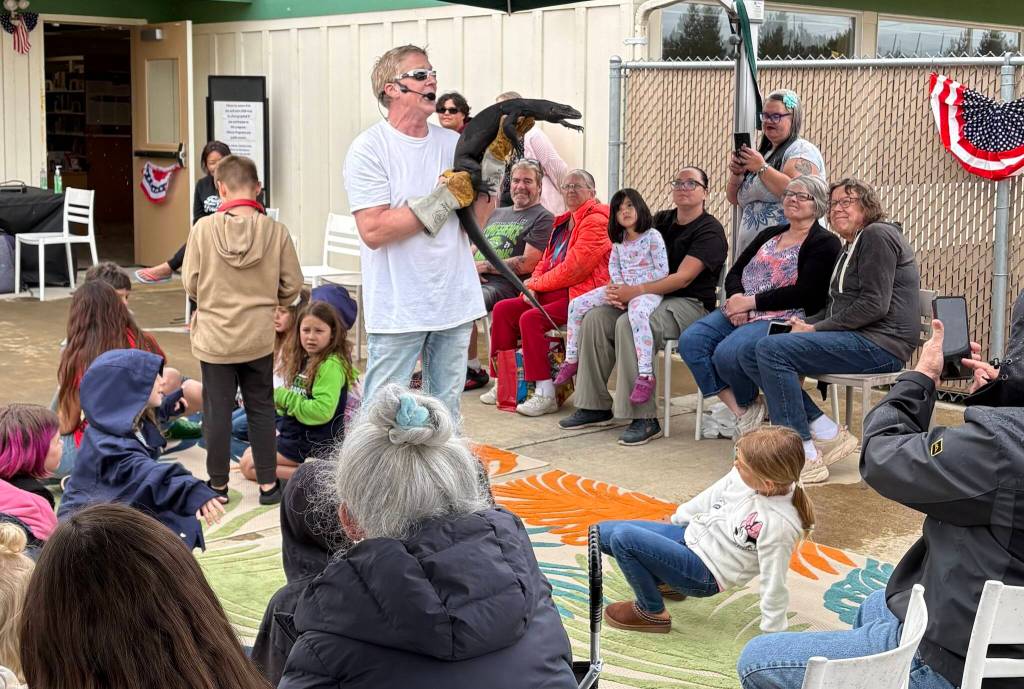 Jerry Knaak / The Daily World
Don Riggs shows off the black dragon lizard known as Toothless to the Reptile Isle visitors at the Ocean Shores Public Library.