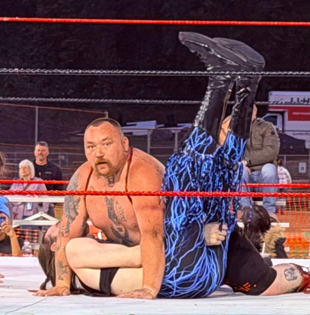 New Rogue Wrestling Attractions Heavyweight Champion HellHound Petrov looks surprised after getting the fall on Pretty Boy Troy Prescott at Red, White, and Bruised.