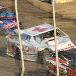 T. Michaels / The Daily World
Current IMCA Modifieds points leader, Craig Moore, in the white #14 car, moves to the inside coming out of turn four at Grays Harbor Raceway earlier this year.