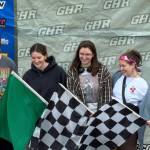 Race fans get their picture taken in front of the victory lane backdrop during Fan Appreciation Night at the Grays Harbor Raceway Friday.