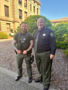 Grays Harbor County Sheriff's Deputy Benjamin Eaton (left) and Sheriff Darrin Wallace pose for a photo after Monday's award ceremony. (Jerry Knaak / The Daily World)