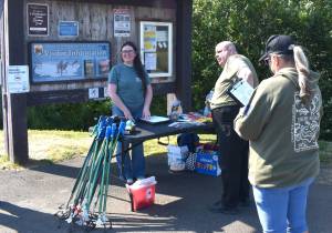 Jerry Knaak / The Daily World
Breana Downs of the Grays Harbor Conservation District checks in volunteers for a clean-up event at the Grays Harbor Wildlife Refuge in Hoquiam.