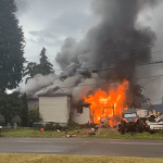 Flames erupt on a home in Cosmopolis on Thursday. (Courtesy photo)
