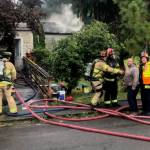 Michael Wagar / The Daily World
A man had to be held back from running inside to rescue his dog trapped inside the burning home.