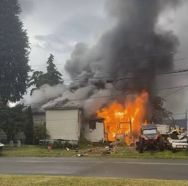 Courtesy photo
Flames erupt on a home in Cosmopolis on Thursday.
