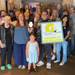 Rick Moyer and Greater Grays Harbor Ambassador Kiona Goodman hold the Member of the Quarter award at their reception at The Music Project. To Moyers right is Viola Gonzalez, his wife Amy and her sister Laura Rohr.