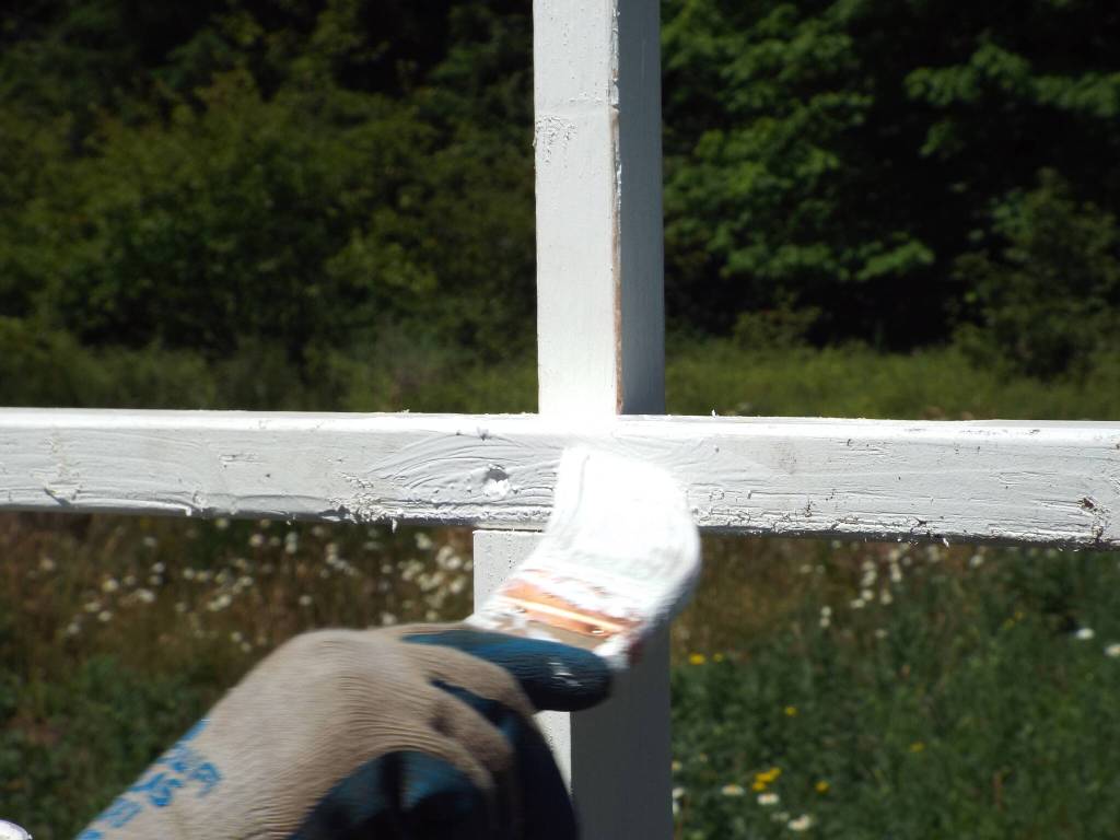 Andrea Watts / The Daily World
A coat of paint touches up the cross after its erected.