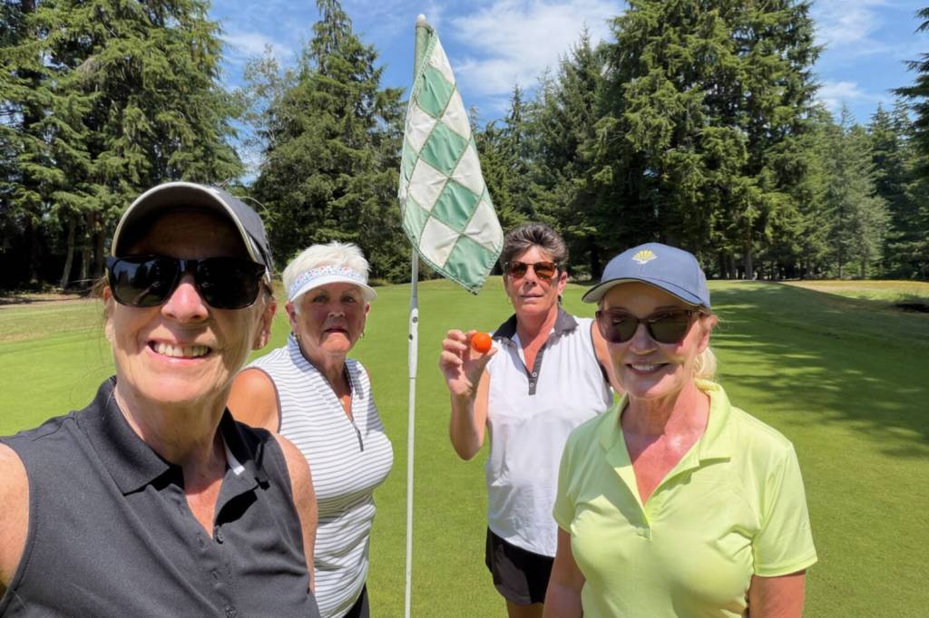 SUBMITTED PHOTOS Tammy wade (second from right) recorded her first ace on Tuesday at Highlands Golf Course in Cosmopolis. Wade used a 7-iron to sink a hole-in-one on the par-3 No. 12 hole. Her shot was witnessed by (from left) Mel Bickar, Cherry Scure and Bonnie Sell.