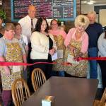 T. Michaels / The Daily World
After an introduction from Greater Grays Harbor Ambassador Kaliegh Aronson, Deidre Williamson cuts the ceremonial ribbon held by GGHI Ambassadors Kiona Goodman (left) and Brooke Chapman at her new location. The Sweet Spot Bakery owner, Toni Spencer, is at the front left in apron.