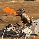 Megasaurus breathes fire while chewing up a car at the Monster Slam at Grays Harbor Raceway.