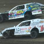 T. Michaels photos / The Daily World
Brenton Schnitzer (top) and Craig Moore start to make their move to the front of the IMCA Modifieds final Saturday at the raceway.