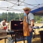 Andrea Watts / The Daily World
At Elmas National Night Out, Police Chief Tracy Gay handled the grilling. Although the East Grays Harbor Fire and Rescue left for a call, they returned in time for the softball game between the police and fire departments.