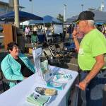 Michelle Traer (left) represented the Ocean Shores Public Library at National Night Out. (Jerry Knaak / The Daily World)