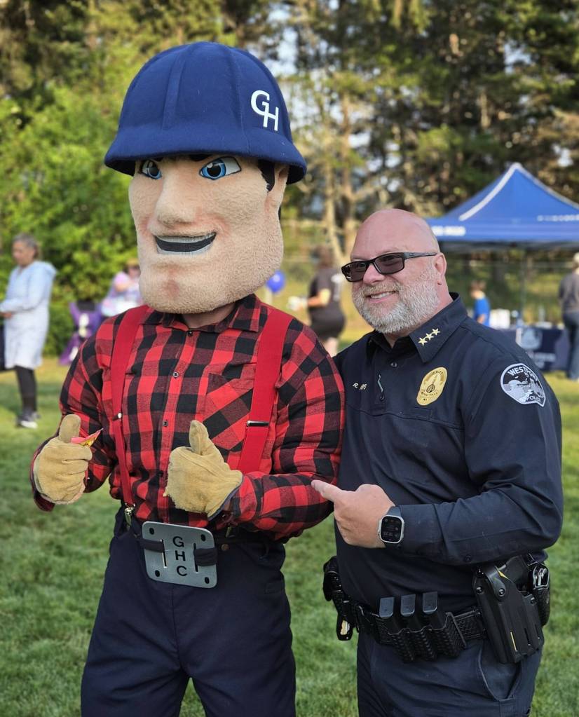 John Shaw / For The Daily World
Westport Chief of Police Ron Phillips poses for a photo with the Grays Harbor College mascot at the Westport National Night Out.
