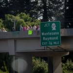 Onlookers pay their respects to the Reed Convoy from the highway overpass at Devonshire.